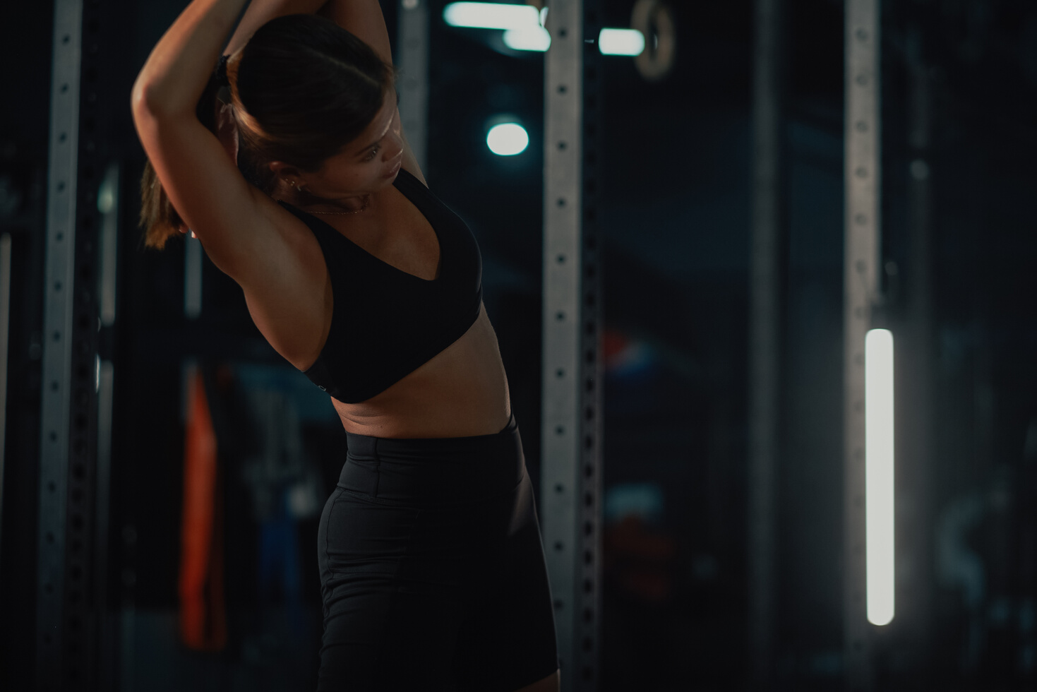 Female Trainers and Weightlifting Woman in a Gym