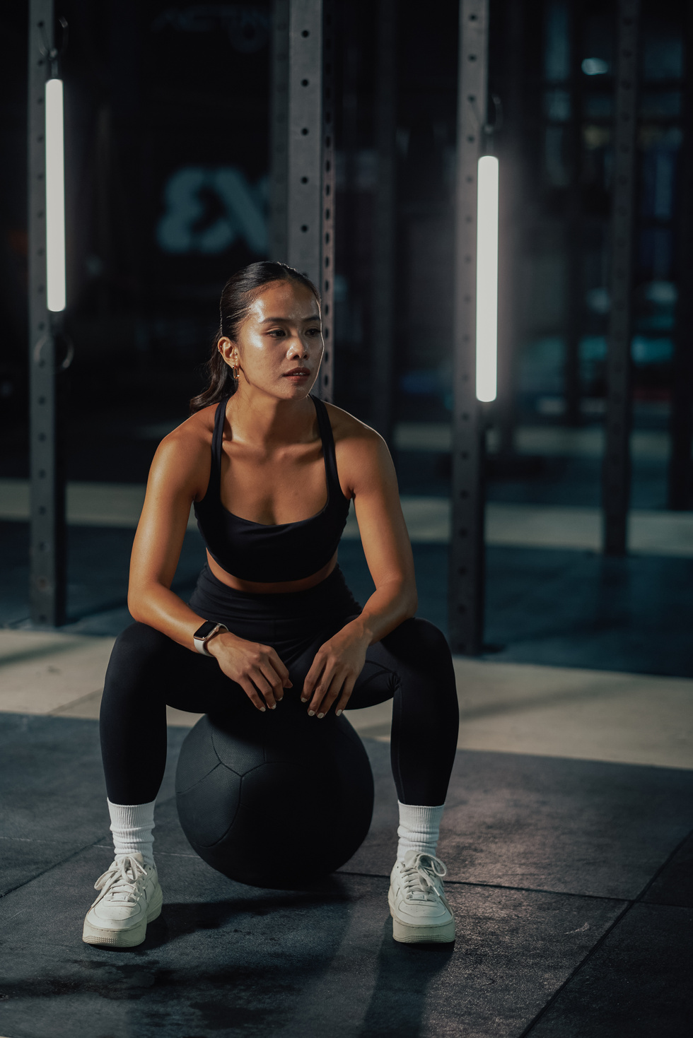 Female Trainers and Weightlifting Woman in a Gym